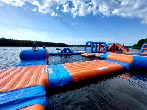 a group of orange and blue inflatable tubes in the water at Domek Na Gwizdówce " u KARGULA" - KASZUBY in Sierakowice