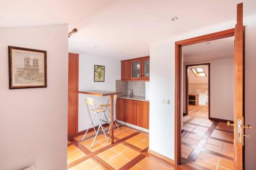 a kitchen with a counter and a table in a room at Maison avec piscine : quinta do sol in Amarante