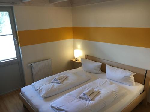 a bedroom with two beds with towels on them at Ferienhaus Müritzhus an der Müritz in Marienfelde