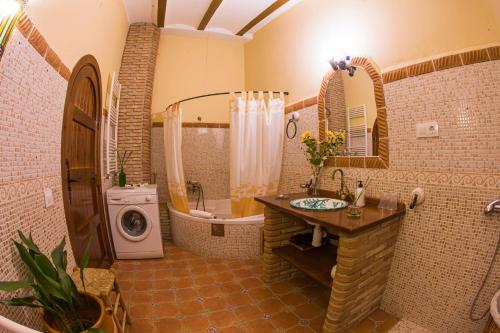 a bathroom with a sink and a tub and a toilet at Casas Cueva Cazorla in Hinojares