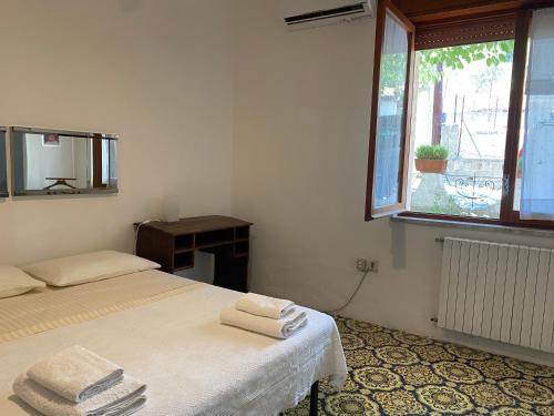 a white room with a bed and a window at Vista Mare a 300 mt dalla spiaggia in Cariati
