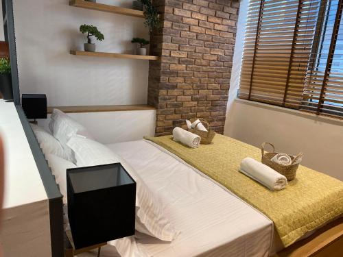 a bedroom with a bed with a tv on it at ladadikathess in Thessaloniki