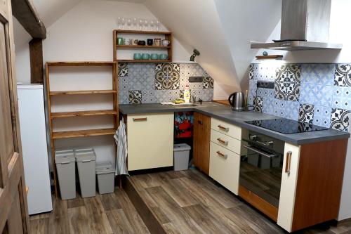 a small kitchen with a sink and a stove at Apartmán Pod střechou - Jelení chata Skladanka in Lučany nad Nisou