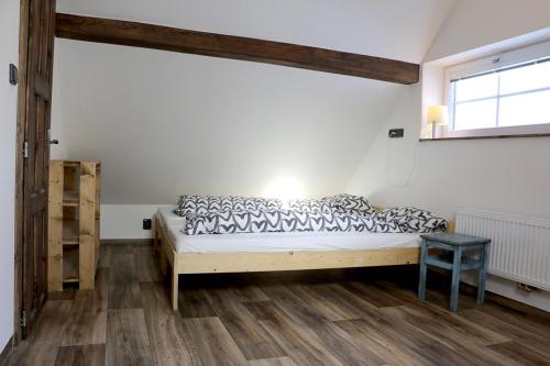 a bedroom with a bed and a window at Apartmán Pod střechou - Jelení chata Skladanka in Lučany nad Nisou