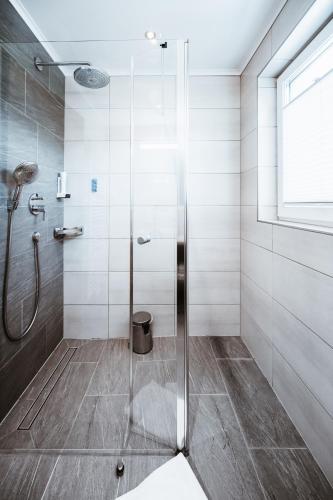 a shower with a glass door in a bathroom at Hotel Schützenhof in Flachau