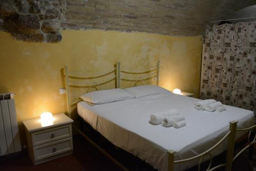 a bedroom with a bed with two towels on it at [Perugia Center] Typical apartment in Perugia