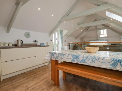 a kitchen with a table in the middle of a room at Trerubies in Delabole