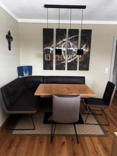 a dining room with a table and chairs and a bench at Heidis Ferienwohnung in Kramsach