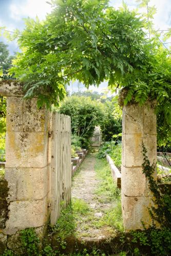an old fence with a tree over it at LA CROIX DES GRANGES in Chapdeuil