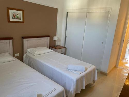 a bedroom with two beds and a closet at Appartamento Costa adeje, Puerto colonn in Adeje