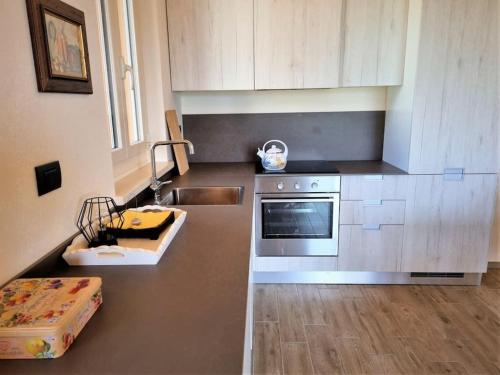 a kitchen with a sink and a stove top oven at Oasi di pace nella Val di Taro in Compiano