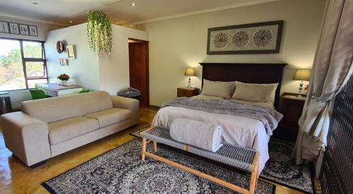 a living room with a bed and a couch at Upstairs R-2 Self-Catering Unit in White River