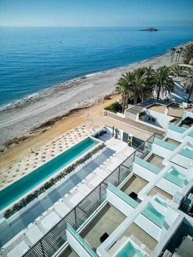 a view of the beach from the balcony of a building at Ancón Suites in Carboneras