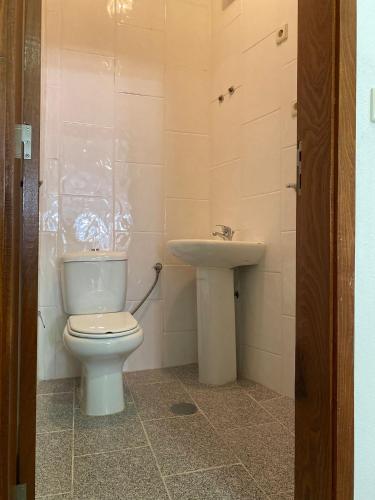 a bathroom with a toilet and a sink at Arcanjo Hostel in Braga