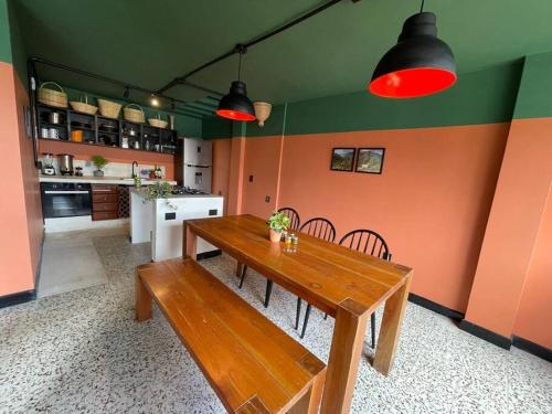 a kitchen with a wooden table and chairs in a room at La Bonita Guesthouse in Bucaramanga