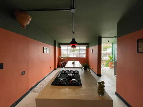 a kitchen with a stove in the middle of a room at La Bonita Guesthouse in Bucaramanga