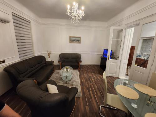 a living room with a couch and a glass table at Gold in Bela Crkva