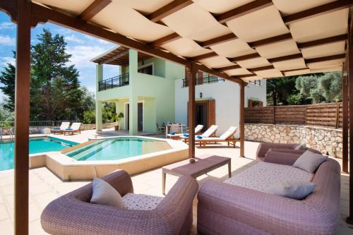 a patio with a swimming pool and a house at Kyknos by Vintage Travel in Meganisi