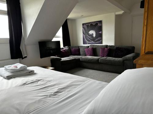 a living room with a bed and a couch at Headlands - Room Only Accommodation in Falmouth