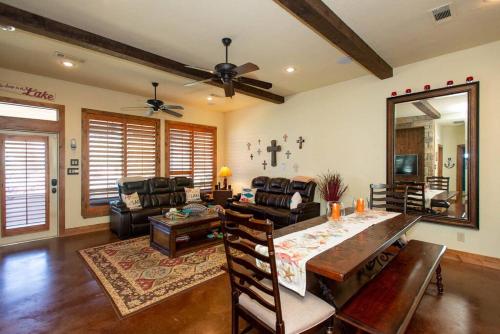 a living room with a table and a couch at Luxurious, Tranquil, 4BR Lakefront Villa in Mabank