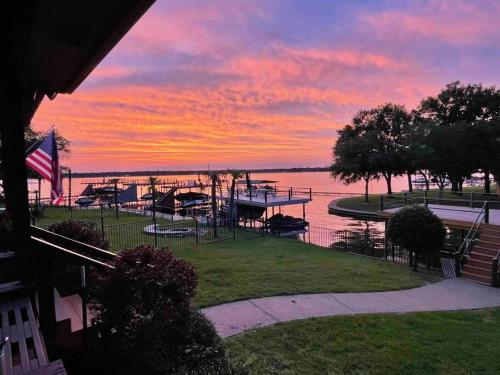 a view of a marina at sunset with a sunset at Luxurious, Tranquil, 4BR Lakefront Villa in Mabank