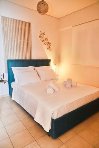 a bedroom with a bed with two stuffed animals on it at 22 Apartment with private parking in Larisa