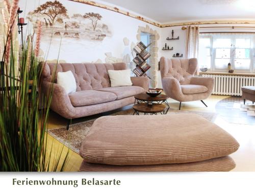 a living room with two couches and a table at Ferienwohnung Belasarte in Bad Elster