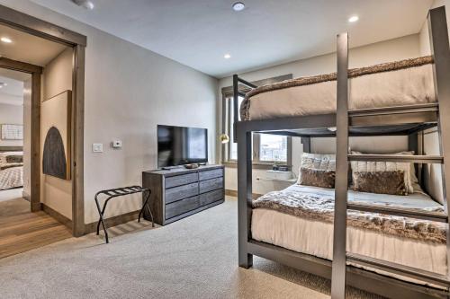 a bedroom with two bunk beds and a television at Winter Park Condo w/Hot Tub & 4 Mi to Skiing in Winter Park