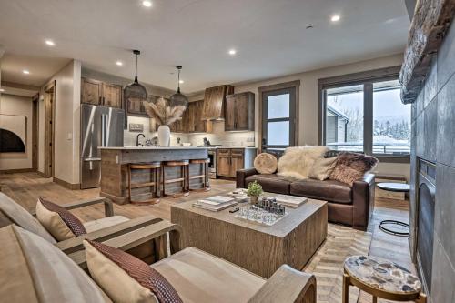 a living room with a couch and a table at Winter Park Condo w/Hot Tub & 4 Mi to Skiing in Winter Park