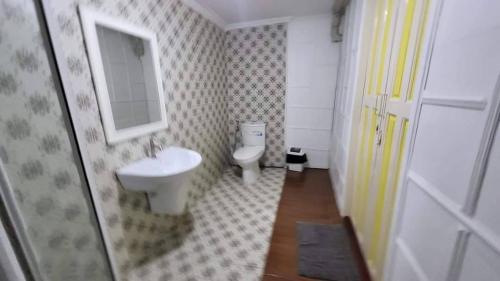 a bathroom with a toilet and a sink and a mirror at AranHostel&Cafe in Ban Bang Khen (1)