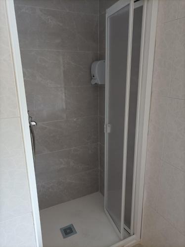 a shower with a glass door in a bathroom at El Ferial in Sarón