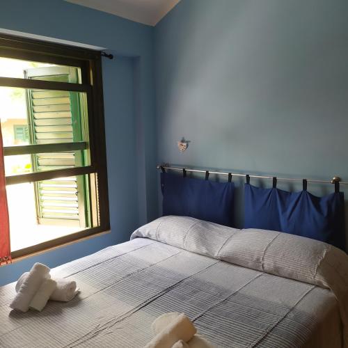 a bedroom with a bed with a teddy bear on it at Appartamento Rais Gerbi in Finale