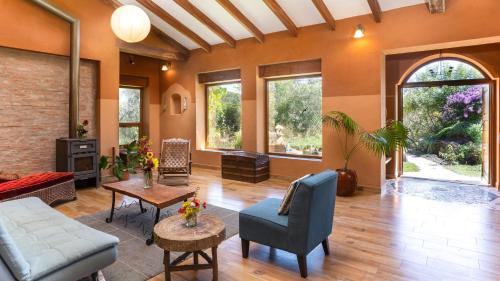 a living room with a couch and a table at Casa Samai Boutique in Samaipata