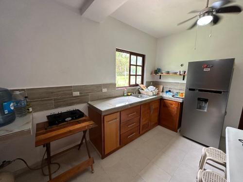 a kitchen with a sink and a refrigerator at Luigi's Glamping in Bacalar