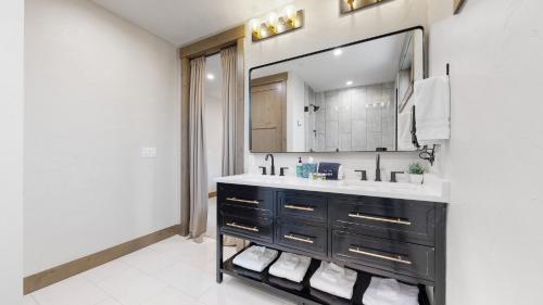 a bathroom with a sink and a mirror at Winter Park Condo w/Hot Tub & 4 Mi to Skiing in Winter Park