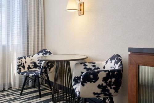 two chairs and a table in a room at The Leo Kent Hotel, Tucson, a Tribute Portfolio Hotel in Tucson