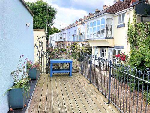 a blue bench sitting on a wooden deck with houses at Prime Location! Detached Clifton Home with Parking in Bristol
