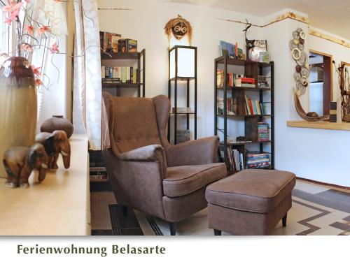 a living room with a reclining chair and a dog at Ferienwohnung Belasarte in Bad Elster