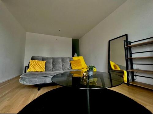 a living room with a couch and a glass table at Sunset Apartment Vienna in Vienna