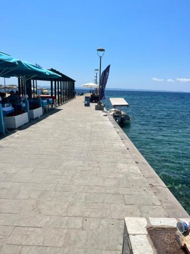 a pier on the water with chairs and tables at Agalmonis in Nikiti