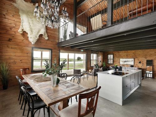 a kitchen and dining room with a table and chairs at Laxá Lodge in Hella