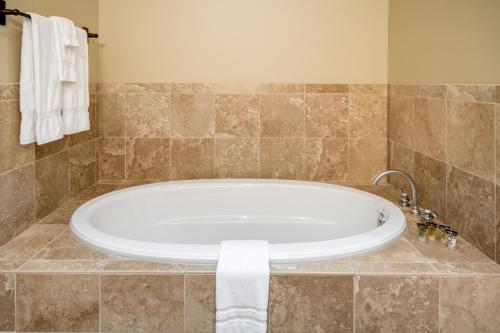 a bath tub in a bathroom with a towel at The Porches in Steamboat Springs