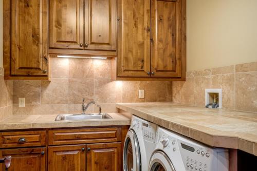 a kitchen with a washing machine and a sink at The Porches in Steamboat Springs