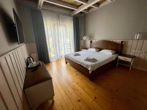 a bedroom with a bed and a large window at Hygge in Tatariv