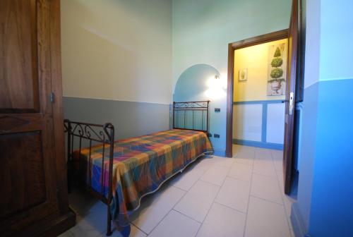 a bedroom with a bed with a colorful blanket on it at Spoleto by the pool in Spoleto
