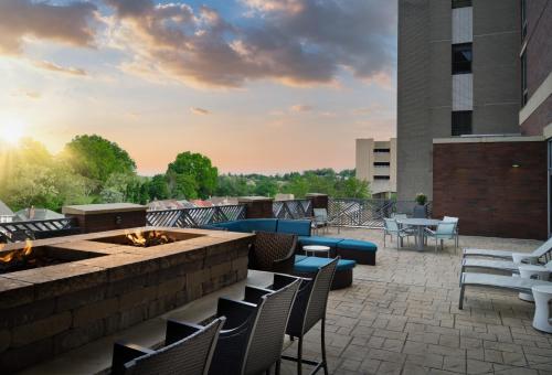 a patio with chairs and a fire pit on a building at SpringHill Suites by Marriott Pittsburgh Mt. Lebanon in Mount Lebanon