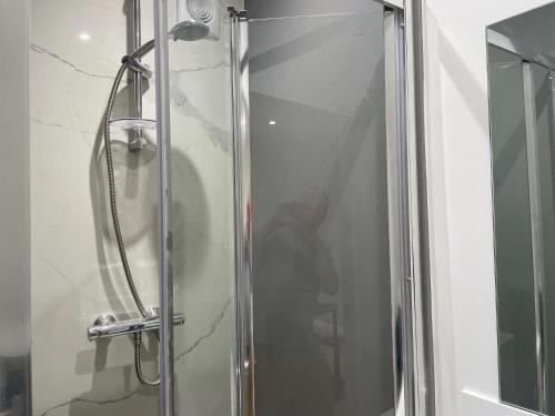 a shower in a bathroom with a glass door at The Greig 1B in Wadhurst