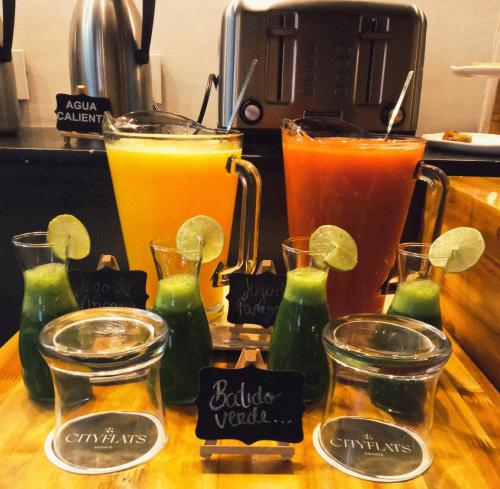 a group of different types of drinks on a counter at Hotel CityFlats in Bogotá