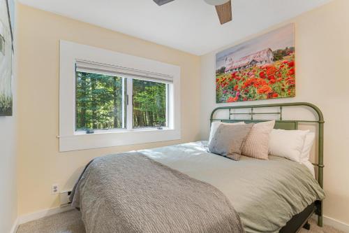 a bedroom with a bed and a window at Bayley Way Getaway in White River Junction