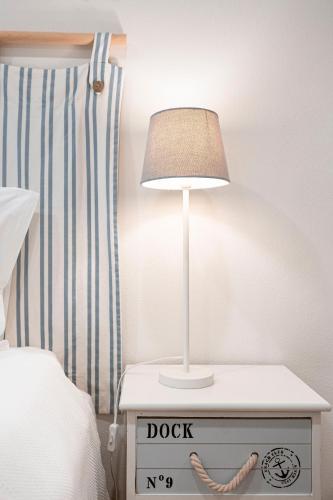 a nightstand with a lamp on top of a bed at Quinta Das Essências in Penafiel